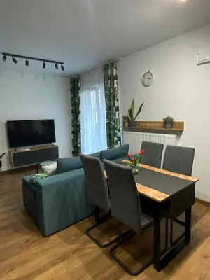 a living room with a couch and a table at EM Room in Kraków
