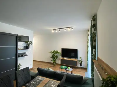a living room with a couch and a tv at EM Room in Kraków