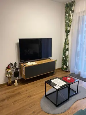 a living room with a large flat screen tv at EM Room in Kraków