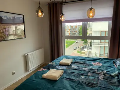 a bedroom with a bed with two pillows on it at Apartment Krakow City-Arena in Kraków