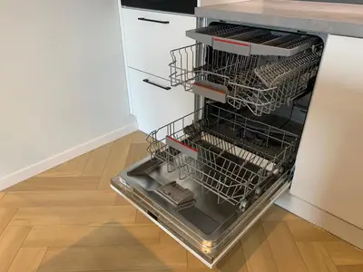 an empty dishwasher in a kitchen with a wooden floor at Apartment Krakow City-Arena in Kraków
