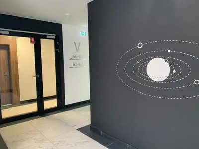 a wall in a building with a drawing of a planet at Apartment Krakow City-Arena in Kraków