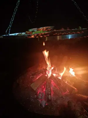 a close up of a fire pit at night at Drewniany domek na wynajem Beskid Wyspowy in Limanowa