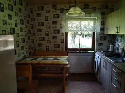 a kitchen with a table and a window at Drewniany domek na wynajem Beskid Wyspowy in Limanowa