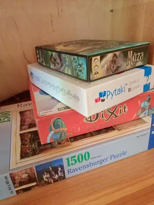 four books stacked on top of each other on a shelf at Drewniany domek na wynajem Beskid Wyspowy in Limanowa