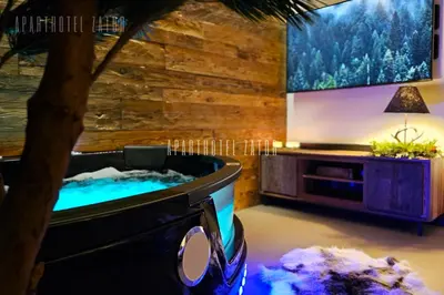 a jacuzzi tub in a room with a tv at Aparthotel ZATOR Natural 56 jacuzzi in Zator