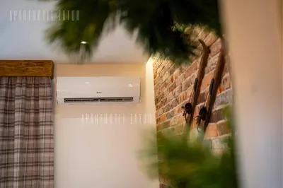 a room with a brick wall with a air conditioner at Aparthotel ZATOR Natural 56 jacuzzi in Zator