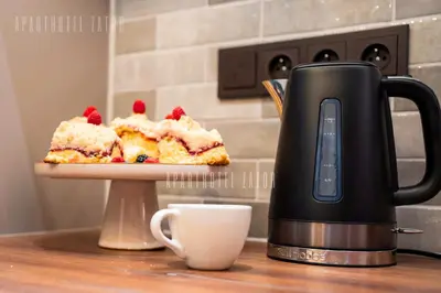 a coffee pot sitting next to a piece of cake at Aparthotel ZATOR Natural 56 jacuzzi in Zator
