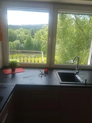 a kitchen counter with a sink and a window at Zaciszny zakątek pod Różą in Skawinki