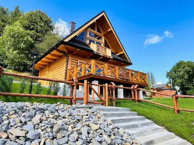 a log cabin with stairs leading up to it at Sielska Chata Beskidy in Zawoja
