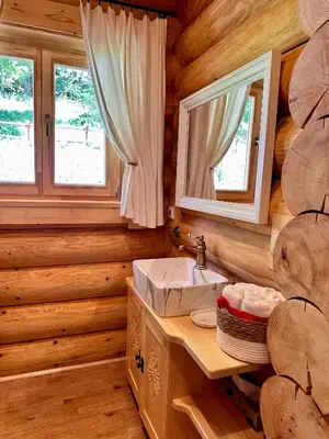a bathroom with a sink in a log cabin at Sielska Chata Beskidy in Zawoja