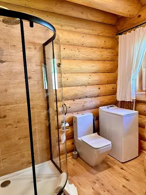 a bathroom with a toilet and a shower at Sielska Chata Beskidy in Zawoja