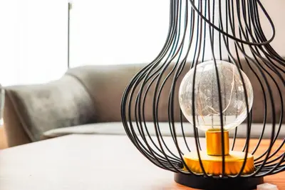 a black lamp sitting on a table at Dom obok lasu pod Krakowem in Zabierzów