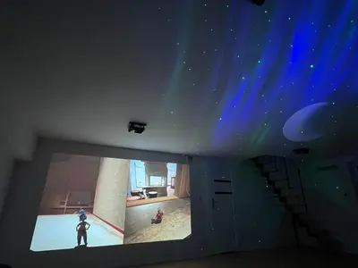 a room with a person standing in a room with lights at Dom obok lasu pod Krakowem in Zabierzów