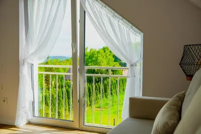 a room with a large window with white curtains at Dom obok lasu pod Krakowem in Zabierzów