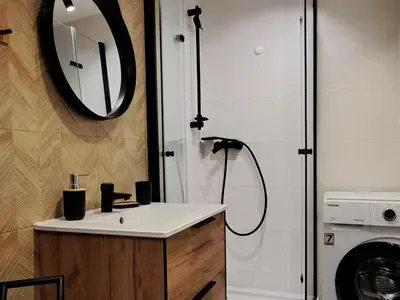 a bathroom with a sink and a mirror at Green Apartament in Oświęcim