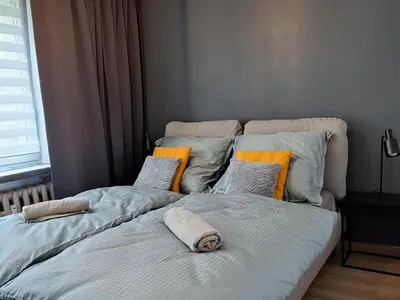a bathroom with a sink and a washing machine at Green Apartament in Oświęcim