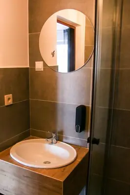 a bathroom with a sink and a mirror at Srokówka Resort in Dąbrówka