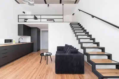 a living room with a staircase and a couch at Kazimierz District - 43 Starowislna Street in Kraków