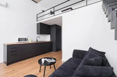 a living room with a couch and a table at Kazimierz District - 43 Starowislna Street in Kraków
