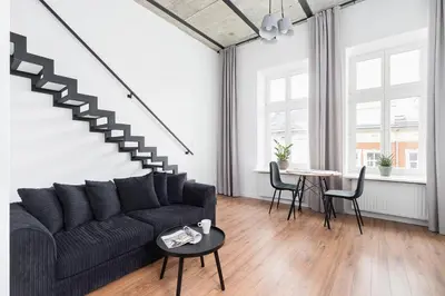 a living room with a couch and a table at Kazimierz District - 43 Starowislna Street in Kraków