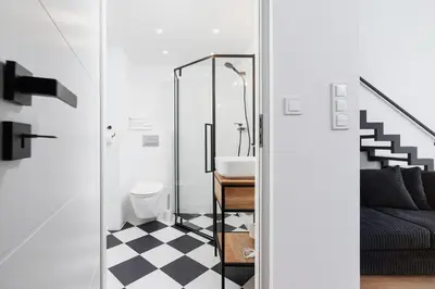 a bathroom with a black and white checkered floor at Kazimierz District - 43 Starowislna Street in Kraków