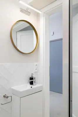 a bathroom with a sink and a mirror at Studio Apartment With Terrace -Starowślna 43 in Kraków