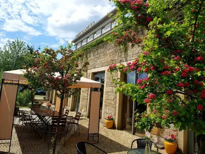 a patio with a table and chairs and flowers at Alibi - Sympozjum Studio in Kraków