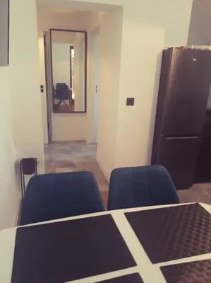 a room with two chairs and a table and a mirror at Apartament Roztoki 4a in Rabka-Zdroj
