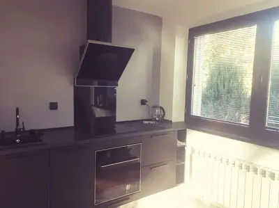 a kitchen with a stove and a sink and a window at Apartament Roztoki 4a in Rabka-Zdroj