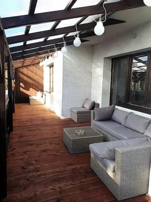 a living room with a couch and chairs on a wooden floor at Apartament Roztoki 4a in Rabka-Zdroj