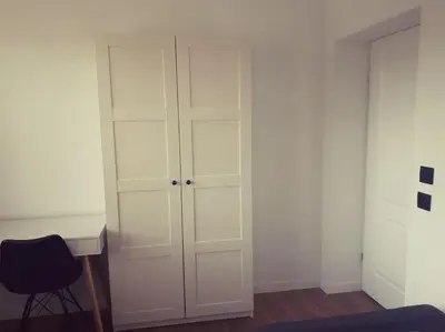 a room with a desk and a white cabinet at Apartament Roztoki 4a in Rabka-Zdroj
