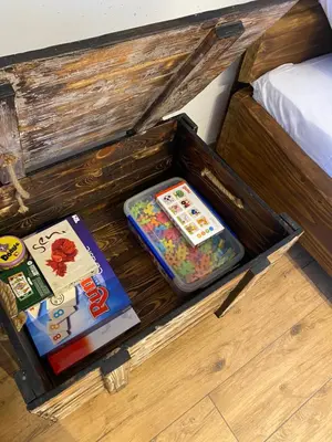 a wooden box with books and other items in it at Zander Village Zator in Palczowice