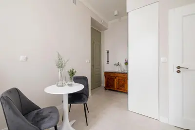 a white room with a table and two chairs at Studio for two - Kazimierz District - Starowiślna 43 in Kraków