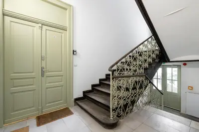 a staircase in a house with a green door at Studio for two - Kazimierz District - Starowiślna 43 in Kraków