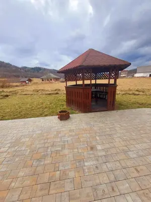 a wooden gazebo with a roof on a field at Apartament u Majki in Bystra