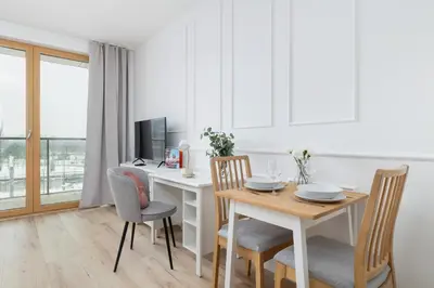 a dining room with a table and a desk with chairs at Pink & Blue Cozy Studio in Kraków by Noclegi Renters in Kraków