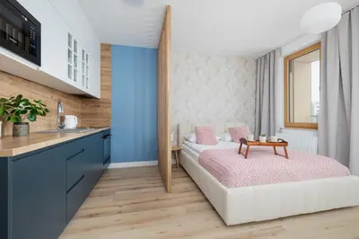 a bedroom with a bed and a table at Pink & Blue Cozy Studio in Kraków by Noclegi Renters in Kraków