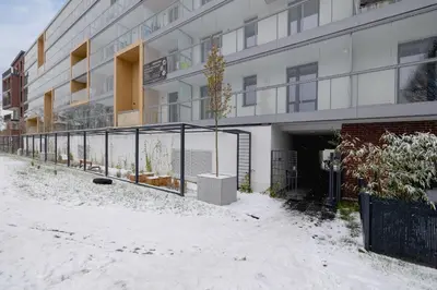 an apartment building with snow on the ground at Pink & Blue Cozy Studio in Kraków by Noclegi Renters in Kraków