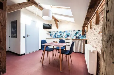 a kitchen and dining room with a table and chairs at 1-bedroom apartment with an AC - Dietla 51 street in Kraków