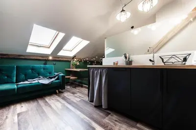 a living room with a green couch and a table at Studio with an AC - Dietla 51 street in Kraków