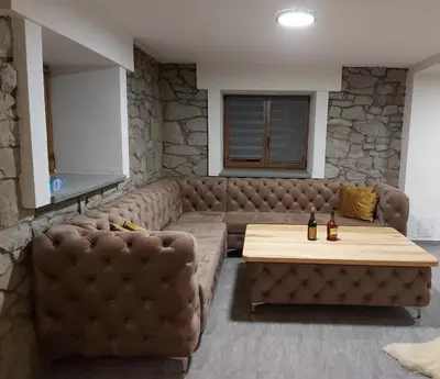 a living room with a couch and a table at Dom pod Turbaczem in Nowy Targ