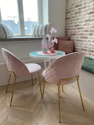 a table with two chairs and a glass bottle on it at Royal Rose Apartment - Old Town Kraków in Kraków