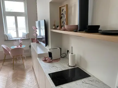 a kitchen with a sink and a fish tank at Royal Rose Apartment - Old Town Kraków in Kraków