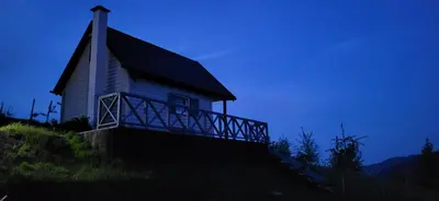 a church on a hill with a blue sky at Domek na Brzeziu in Limanowa