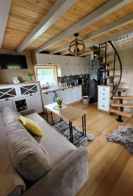 a living room with a couch and a table at Domek na Brzeziu in Limanowa