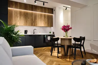a kitchen and living room with a table and chairs at Apartament Indigo 11 by Housine in Zator