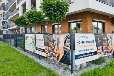 a row of signs in front of a building at Apartament Indigo 11 by Housine in Zator