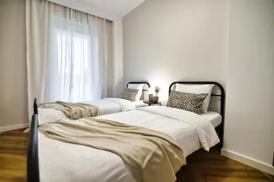 two beds in a room with a window at Apartament Indigo 11 by Housine in Zator