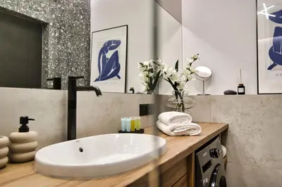 a bathroom with a white sink and a mirror at Apartament Indigo 11 by Housine in Zator
